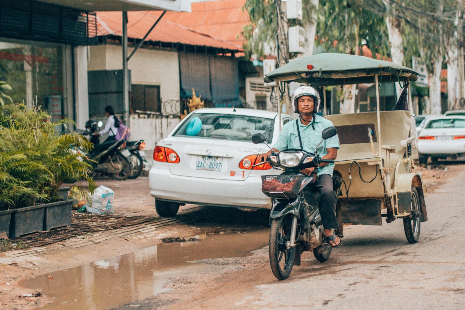 Man on a tuk tuk scooter in South East Asia