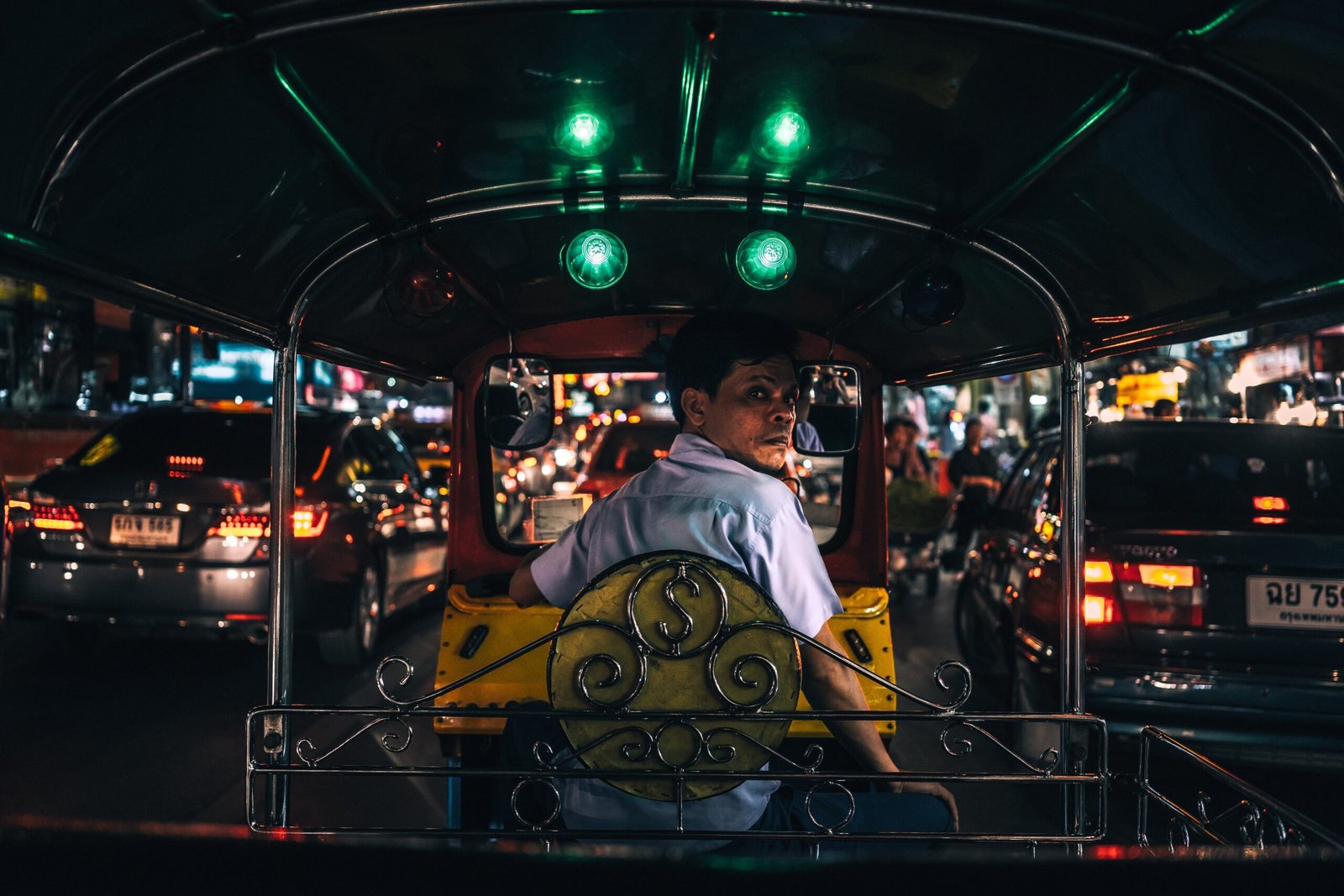 Tuk tuk driver in South East Asia at night time 