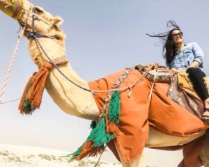 Sitting on a camel in the desert of Qatar