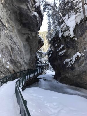 Hiking Johnston's Canyon in winter is one of the top attractions in the Banff National Park that brings tourists to the area. If you're looking for a guide on what the popular hike is like in winter, what to wear, and what you'll see, here is everything you need to know! #lakelouise #johnstonscanyon #banff